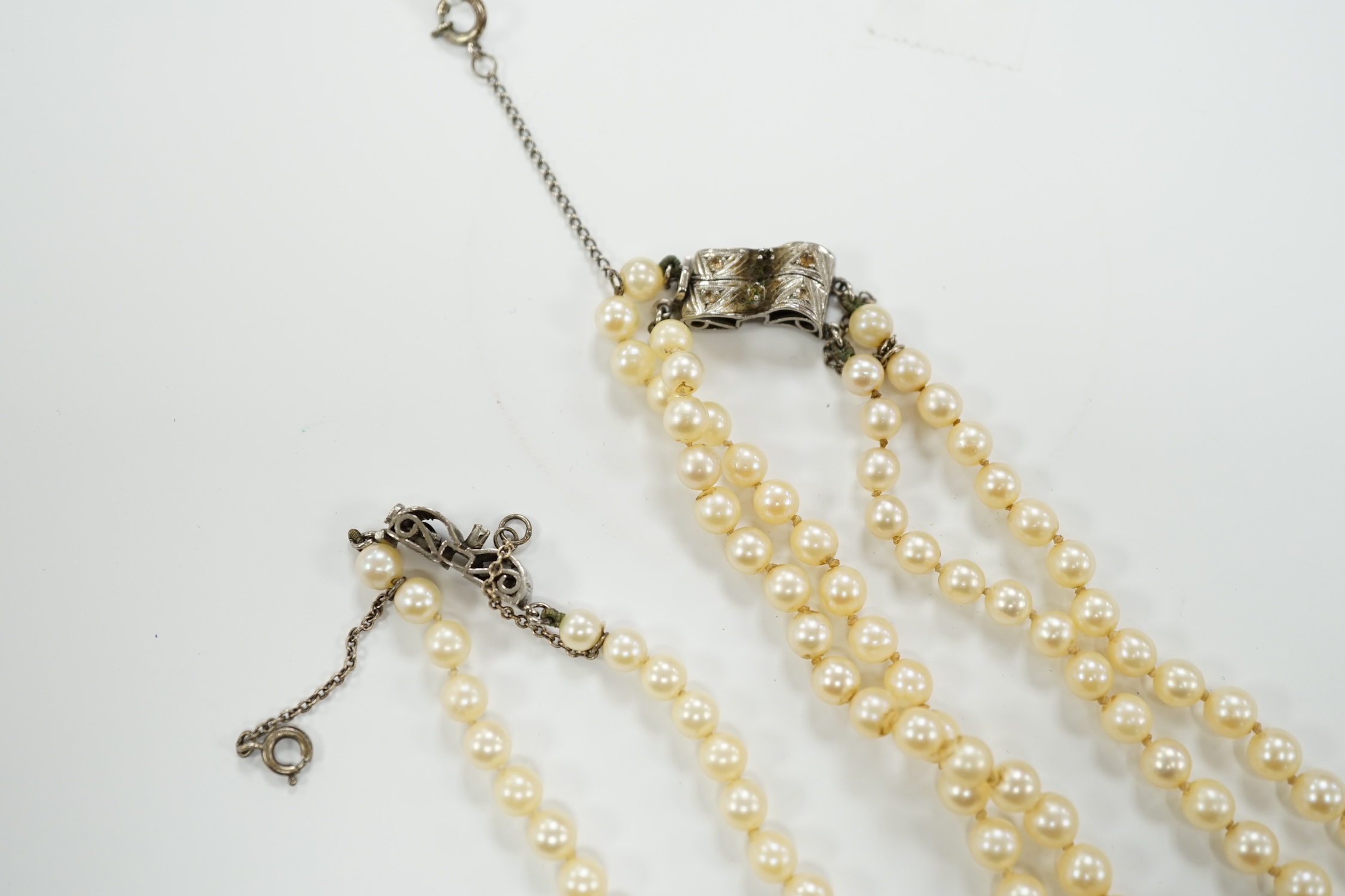 A double strand graduated cultured pearl necklace, with a white metal clasp, 48cm, together with a similar single strand graduated cultured pearl necklace